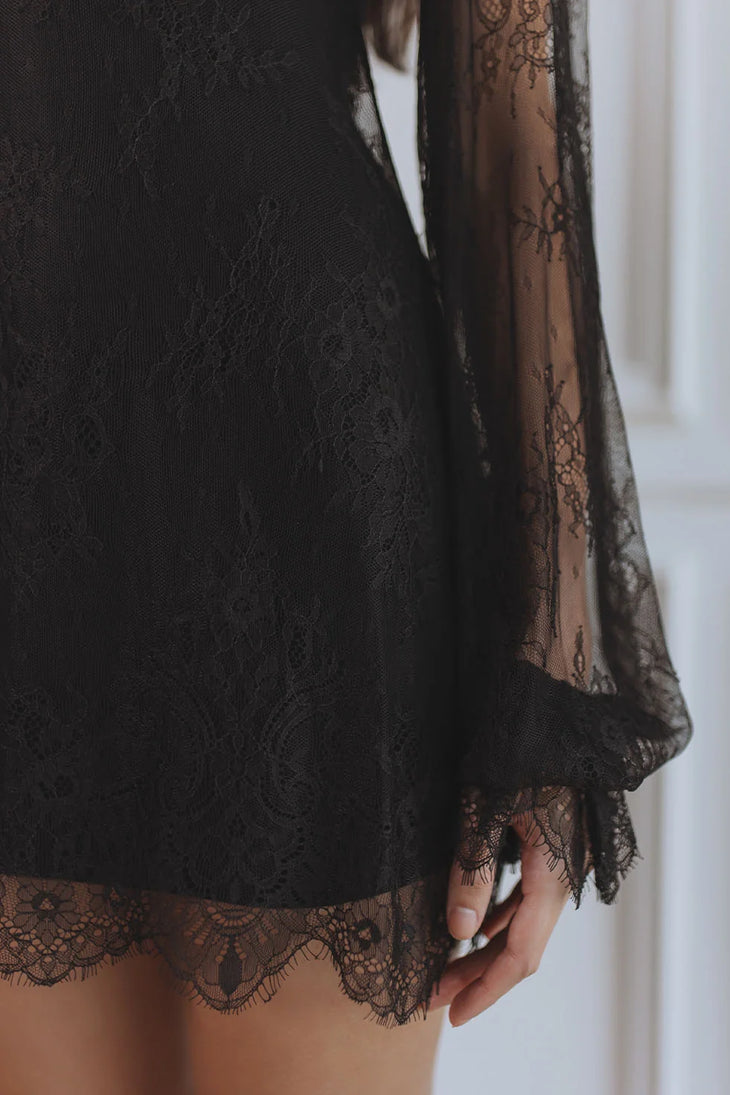 Woman wearing black lace mini dress with sheer long sleeves — Chic Le Frique | Endless UAE