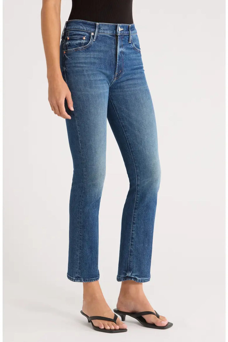 Woman wearing blue denim ankle bootcut jeans with black sandals — Mother | Endless UAE