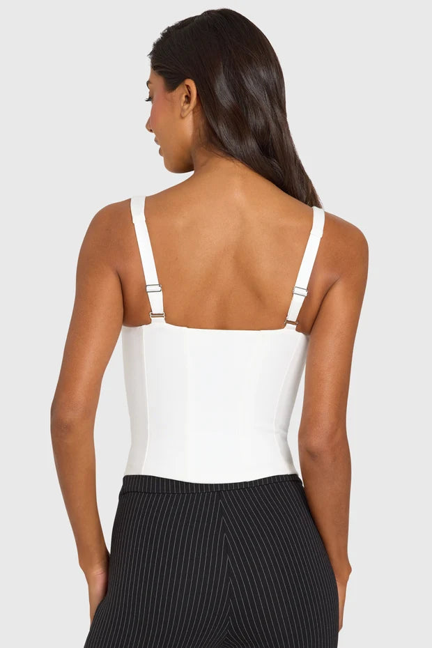 White sleeveless scoop neck corset top paired with black ribbed capri leggings — Oh Polly | Endless UAE