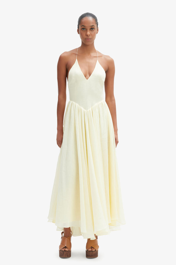 Woman wearing cream halter maxi dress with full skirt and wooden platform sandals — Bardot | Endless UAE