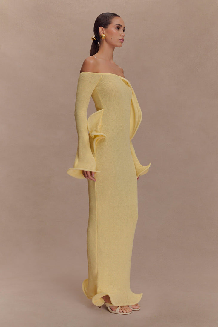 Woman wearing yellow off-shoulder ribbed knit maxi dress with ruffled details — Meshki | Endless UAE