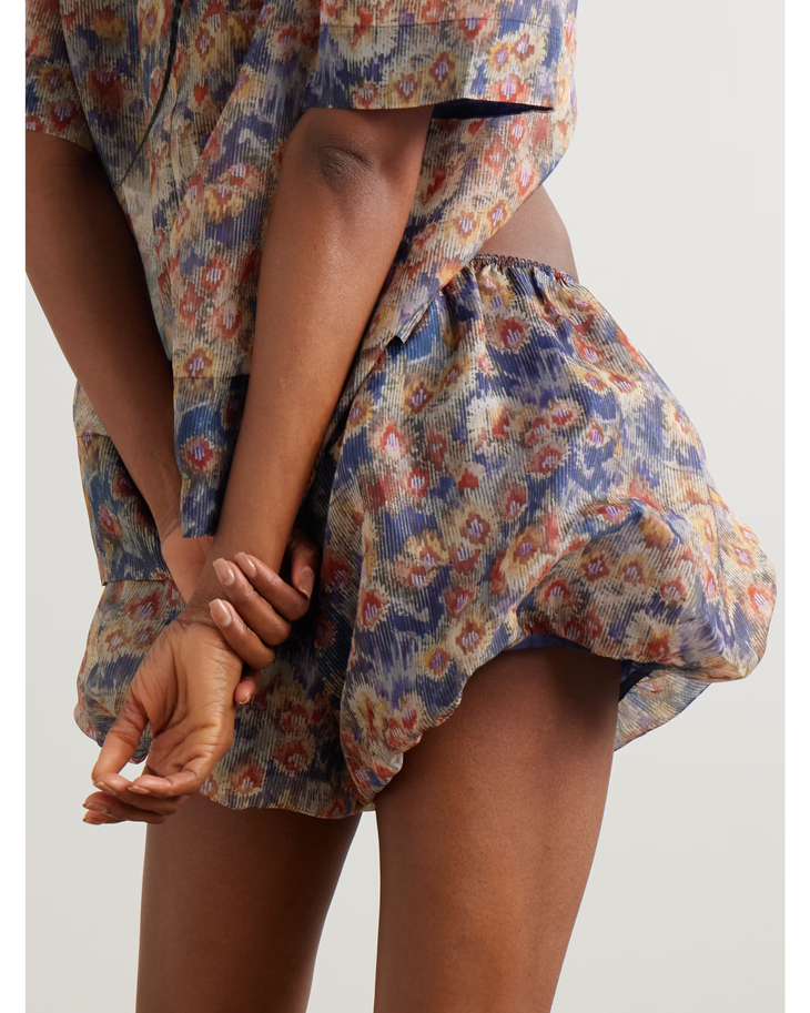 Woman wearing floral-print silk-organza shirt and shorts with brown woven bag — Sir The Label | Endless UAE