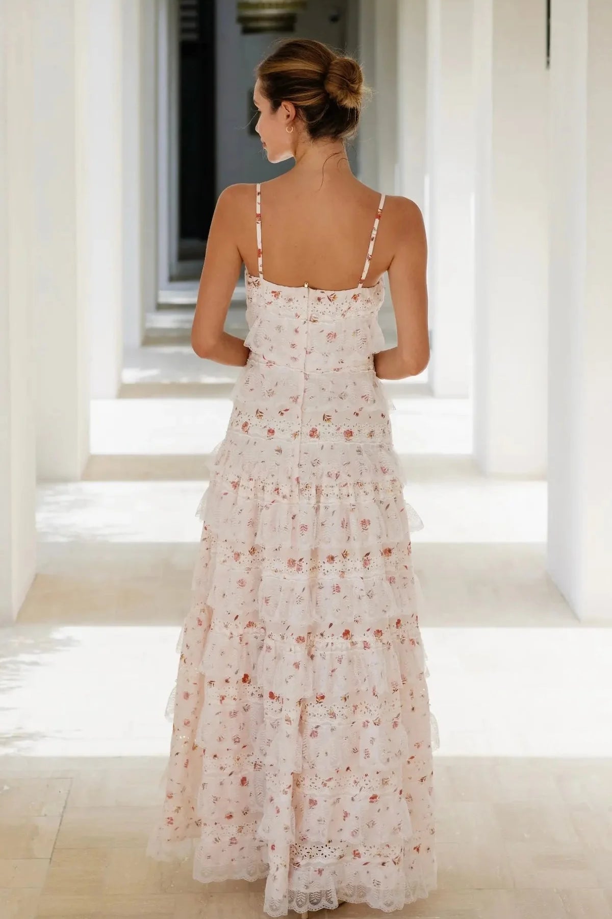 Woman wearing blush floral maxi dress with tiered lace skirt and adjustable straps — Anne Louise Boutique | Endless UAE