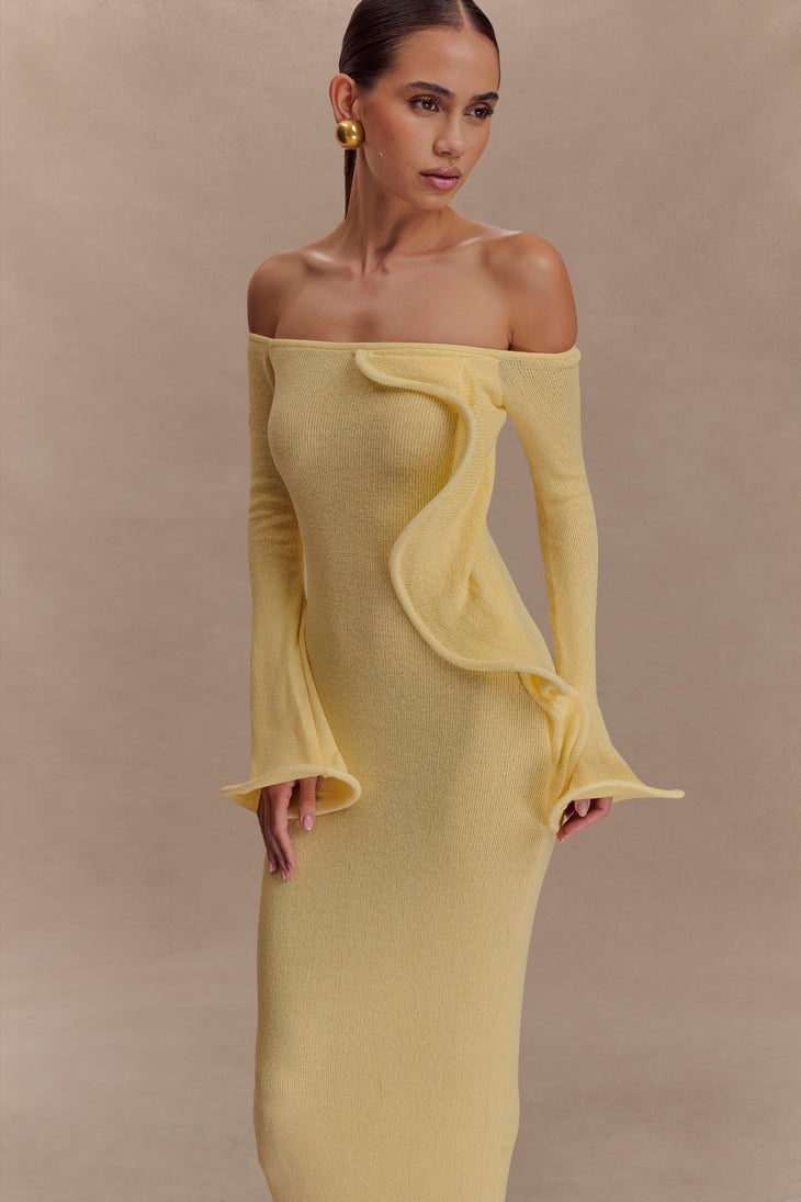 Woman wearing yellow off-shoulder ribbed knit maxi dress with ruffled details — Meshki | Endless UAE