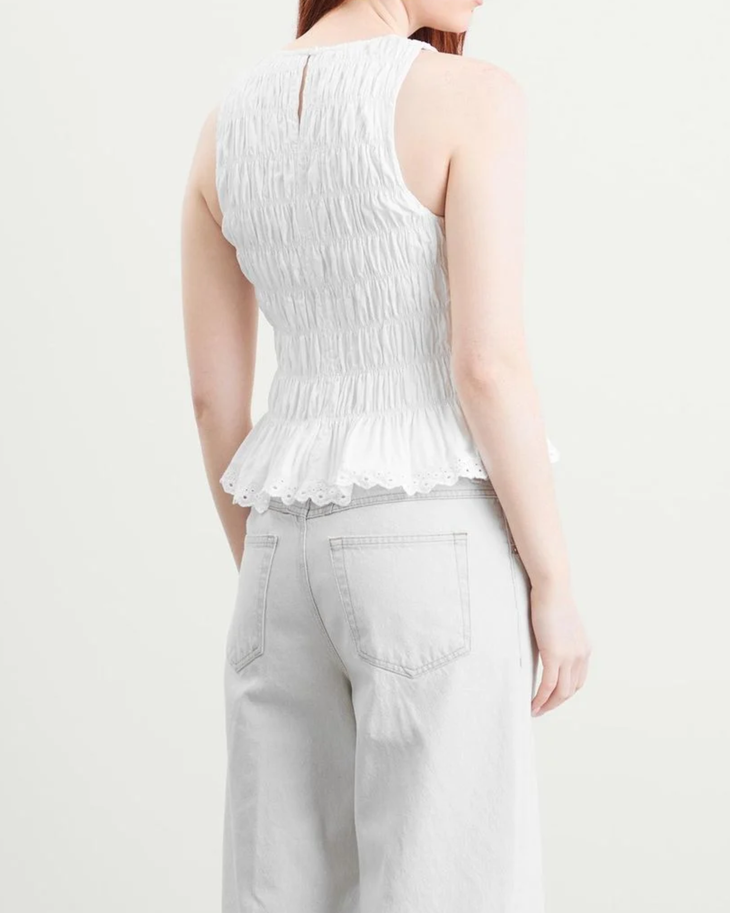 White ruched sleeveless top with lace hem paired with light denim jeans — Faithful The Brand | Endless UAE