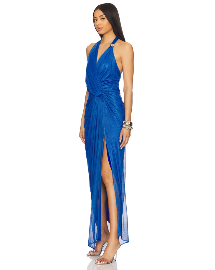 Woman wearing royal blue halter wrap maxi dress with draped side slit and gold accessories — Baobab | Endless UAE