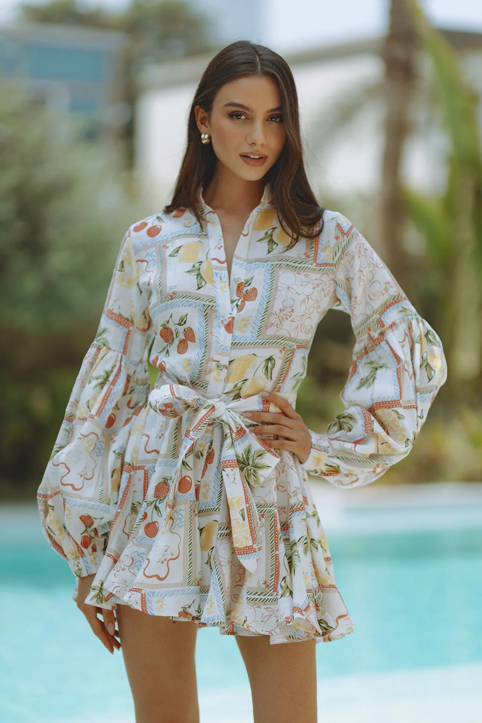 Woman wearing Tessa Linen Mini Dress with fruit print and puffed sleeves — Chic Le Frique | Endless UAE