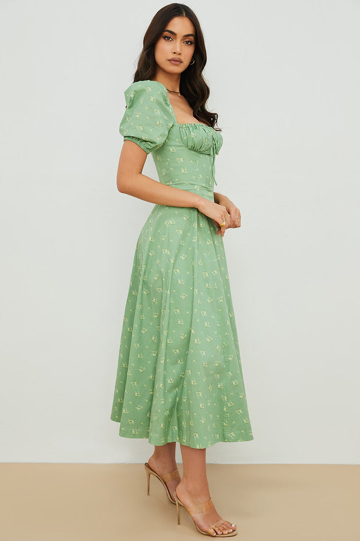 Woman wearing a green floral puff sleeve midi dress with a slit — House of CB | Endless UAE