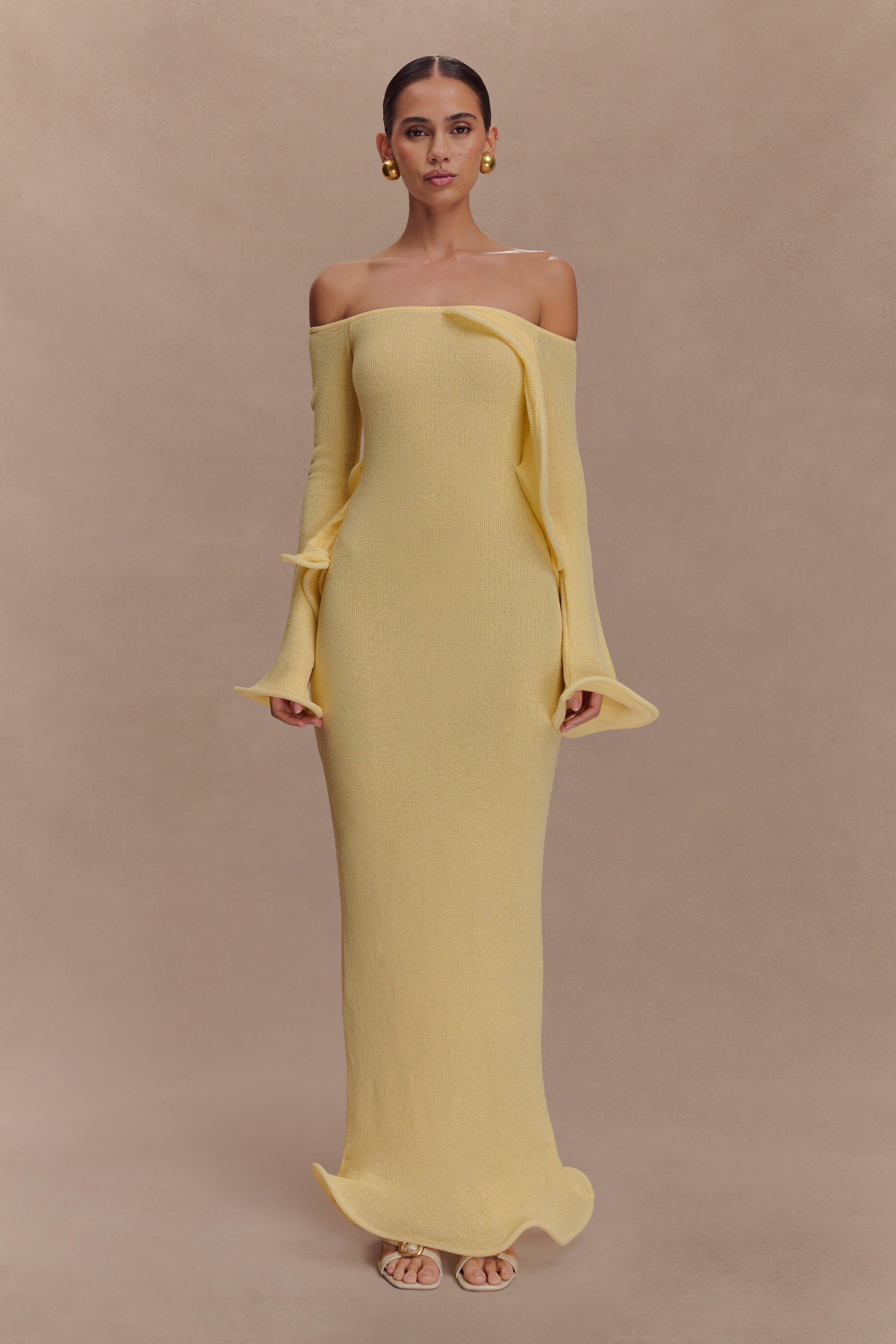 Woman wearing yellow off-shoulder ribbed knit maxi dress with ruffled details — Meshki | Endless UAE