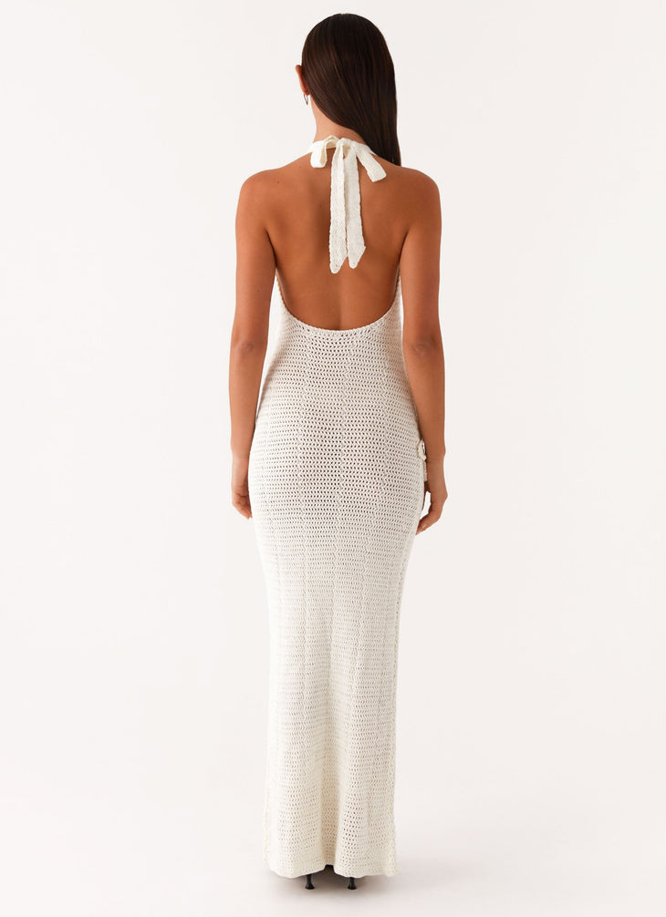 Woman wearing cream crochet halter maxi dress with floral appliqués — Peppermayo | Endless UAE