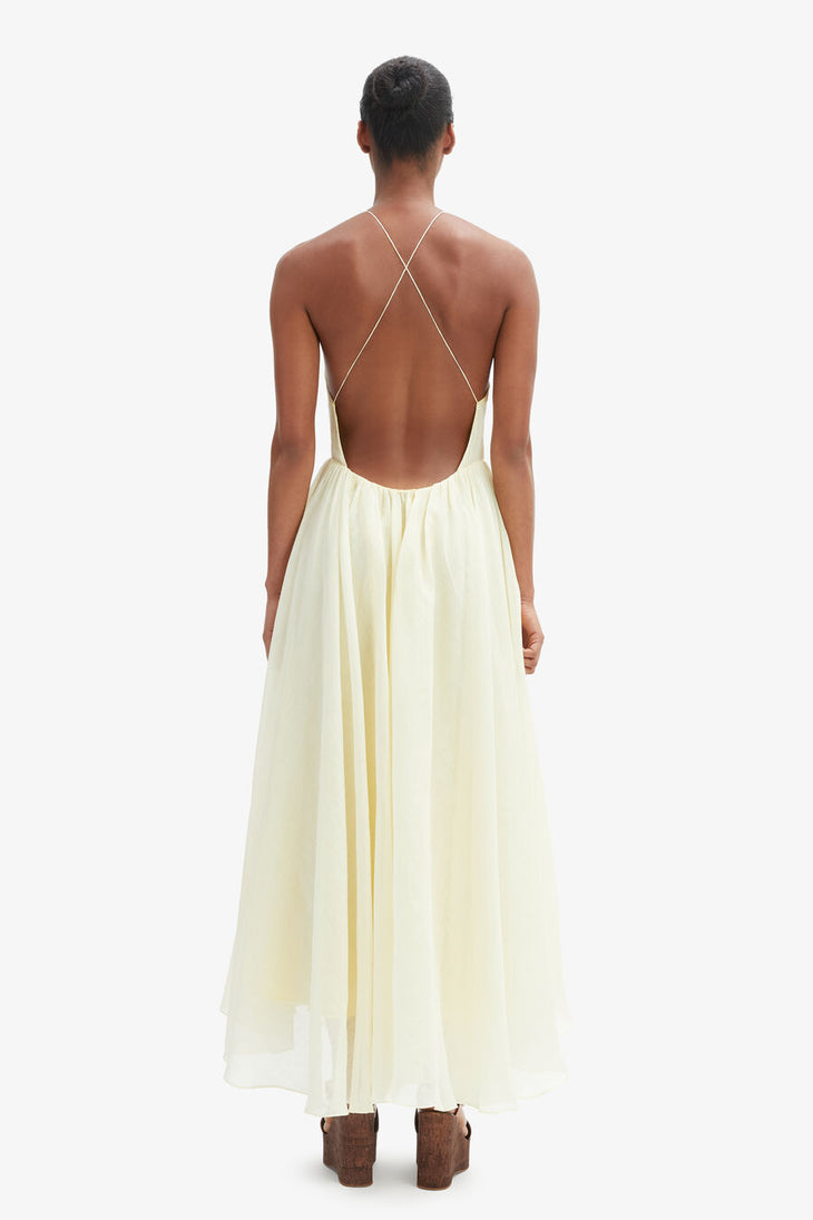 Woman wearing cream halter maxi dress with full skirt and wooden platform sandals — Bardot | Endless UAE