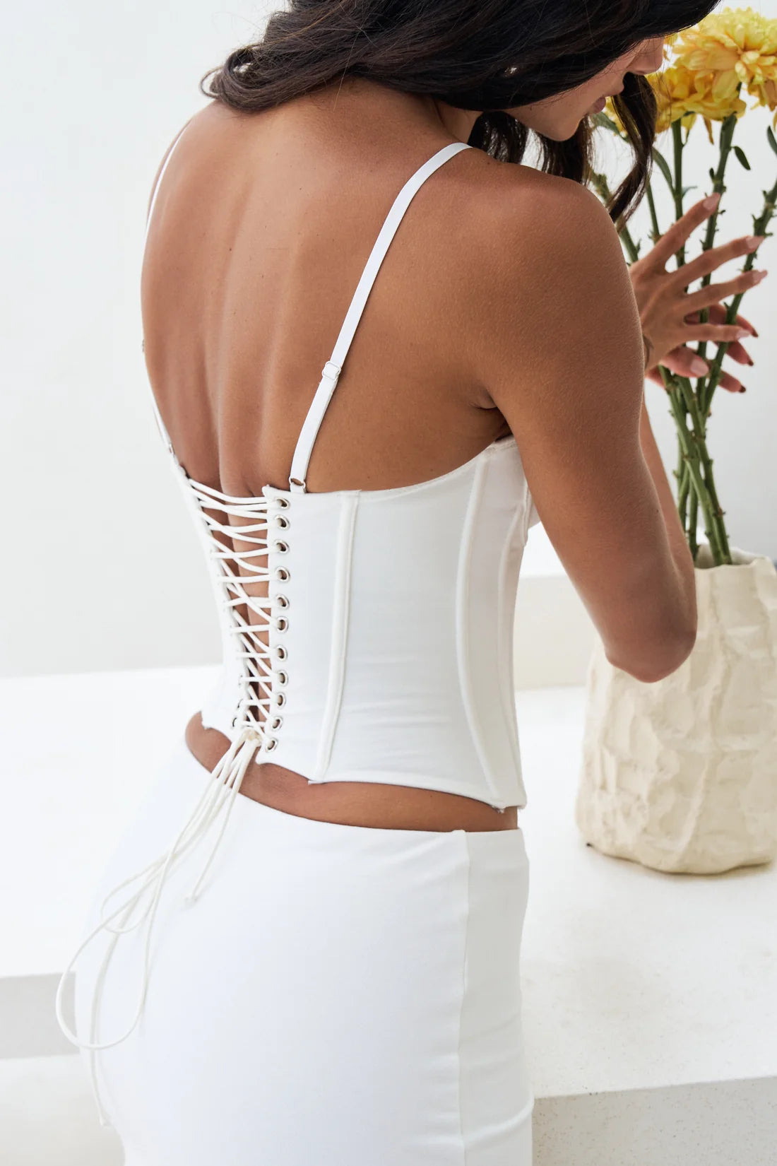 White lace-up corset top with open back design and spaghetti straps — By Alle | Endless UAE