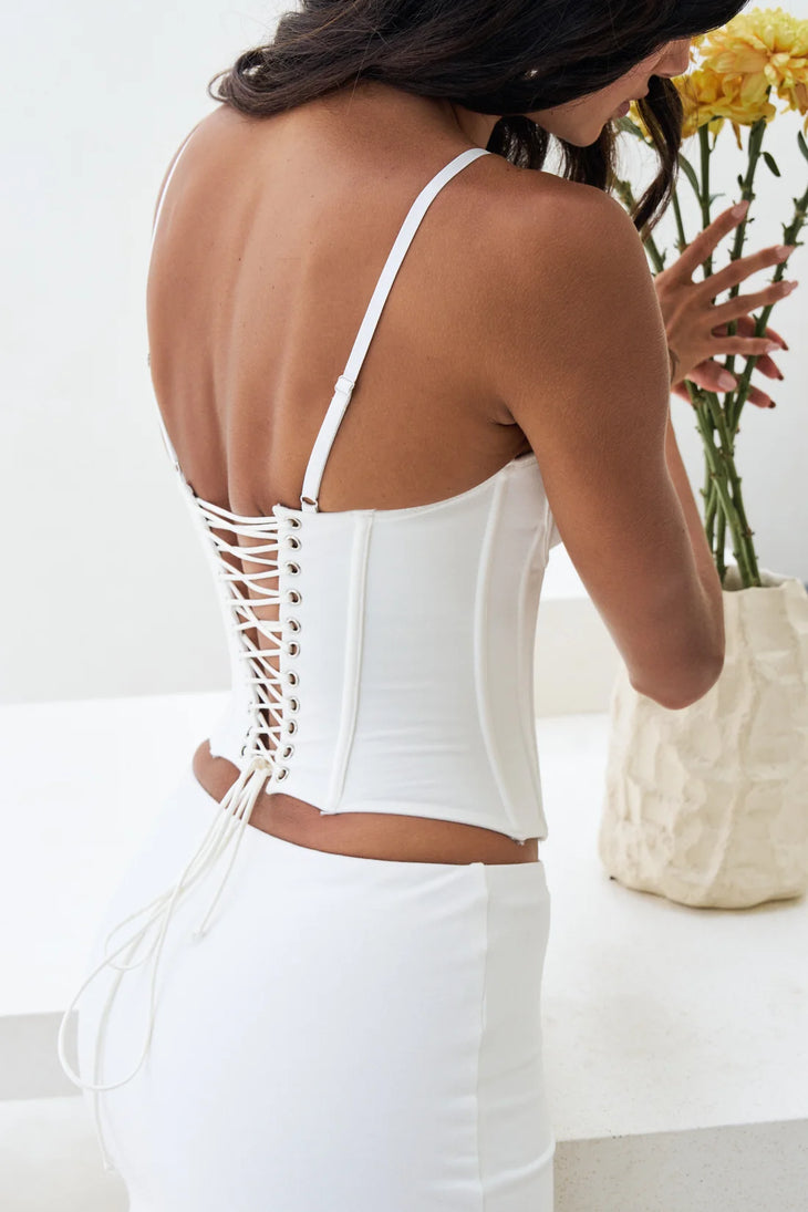 White lace-up corset top with open back design and spaghetti straps — By Alle | Endless UAE