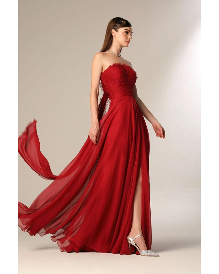 Woman wearing deep red strapless flowing gown with draped train — Velvety Couture | Endless UAE