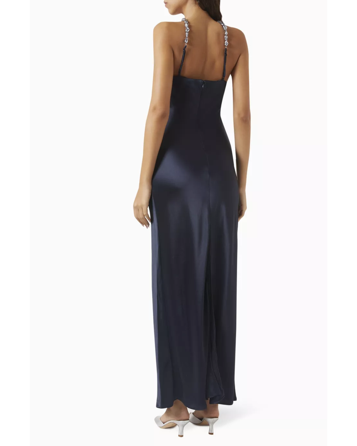 Woman wearing navy halter maxi dress with pearl-embellished neckline and metallic sandals — Staud | Endless UAE
