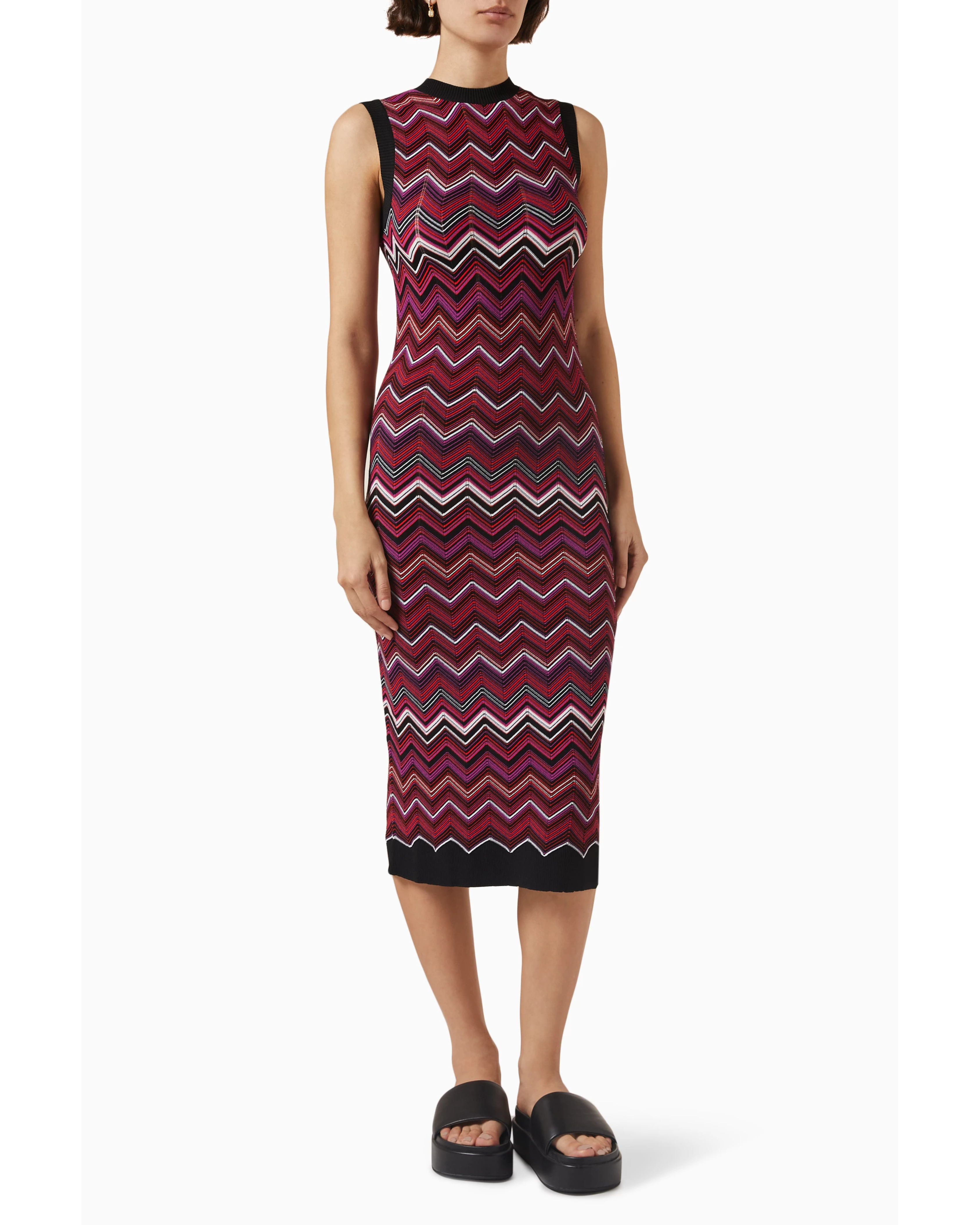 Woman wearing burgundy sequin zigzag midi dress with black trim and platform slides — Missoni | Endless UAE