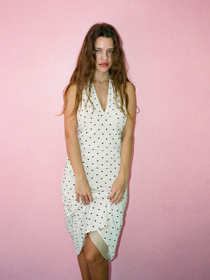Woman wearing white halter midi dress with black polka dots — Réalisation Par | Endless UAE