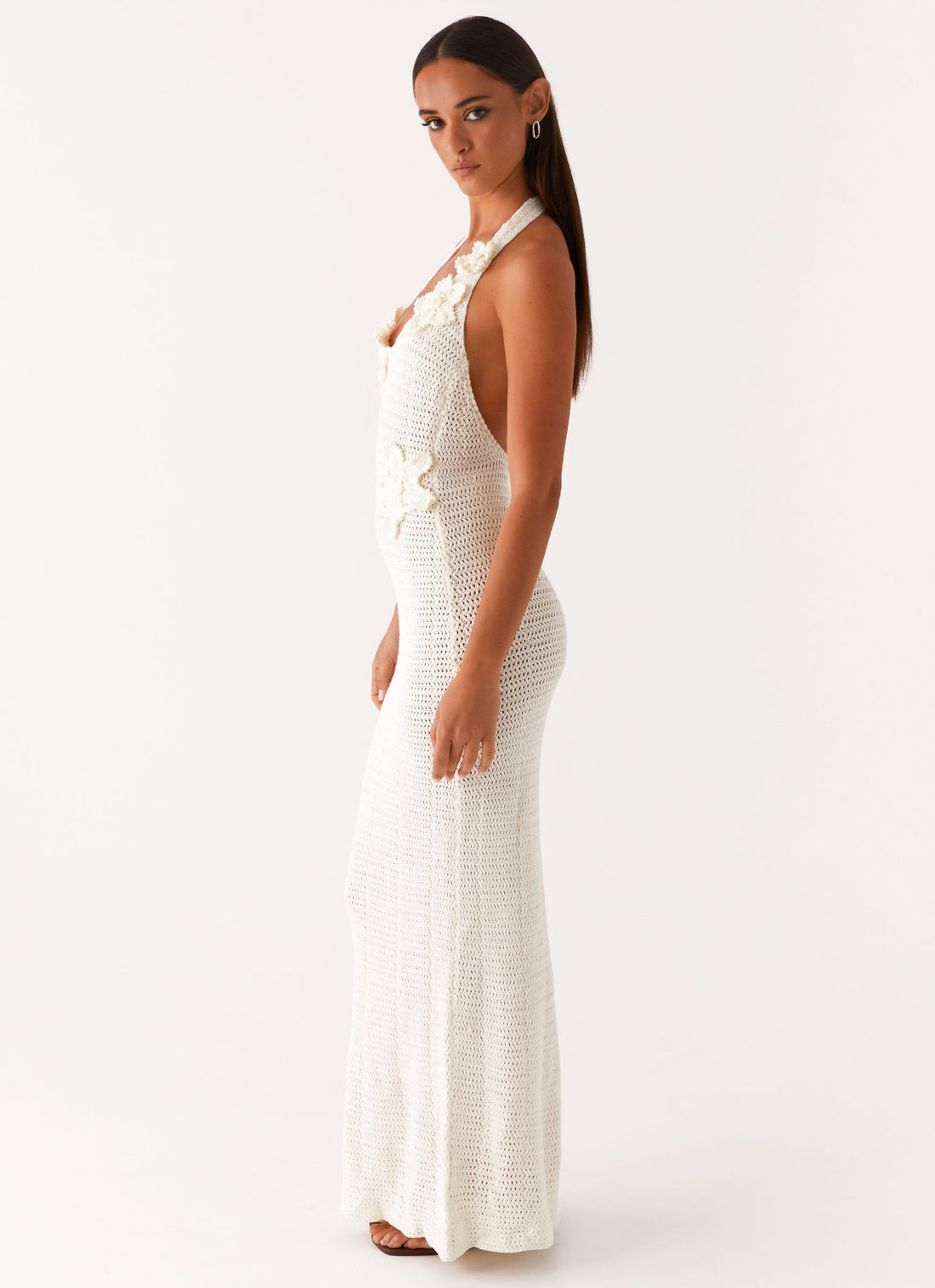 Woman wearing cream crochet halter maxi dress with floral appliqués — Peppermayo | Endless UAE