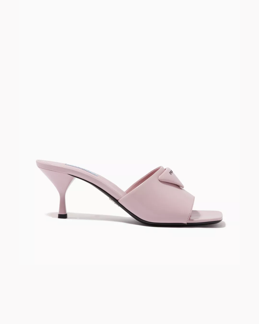 Light pink mule heels with triangle logo detail worn with black midi skirt — Prada | Endless UAE