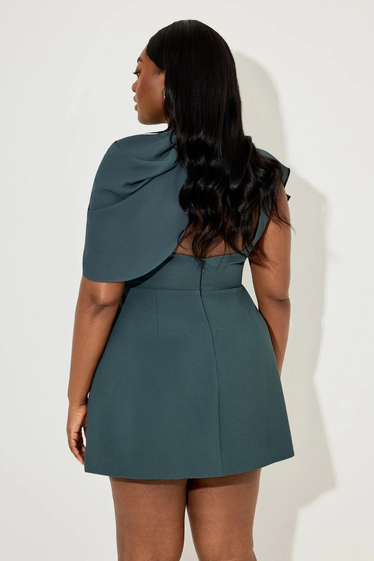 Woman wearing teal gathered mini dress with draped cape detail and white sandals — Aaizel11 | Endless UAE