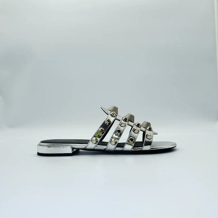 Silver studded flat sandals with black straps and metallic accents — Balenciaga | Endless UAE