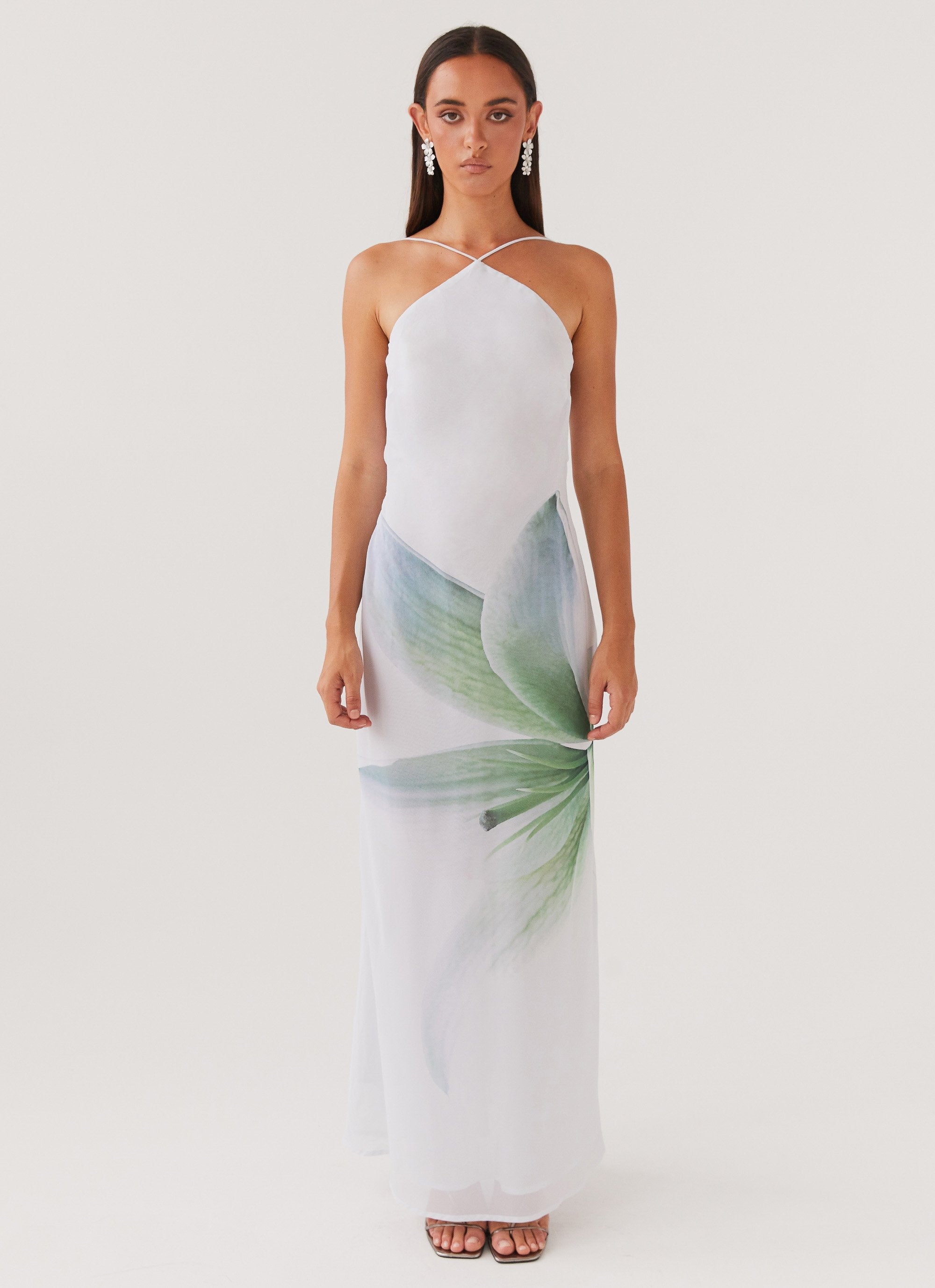 Woman wearing white halter maxi dress with green floral print — Peppermayo | Endless UAE