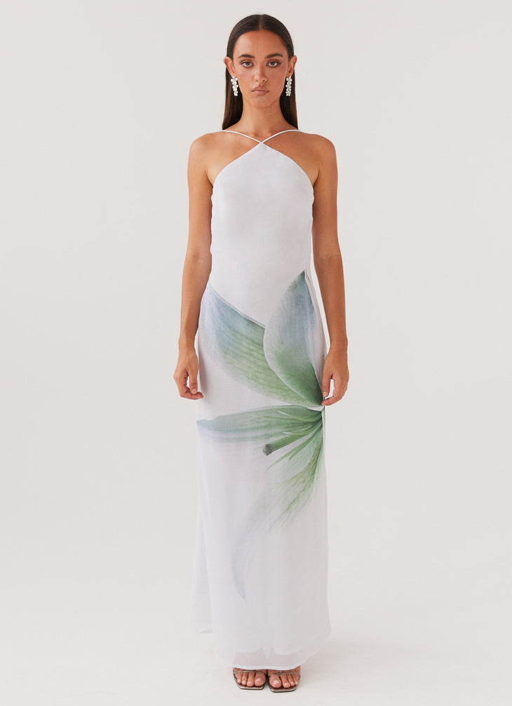 Woman wearing white halter maxi dress with green floral print — Peppermayo | Endless UAE