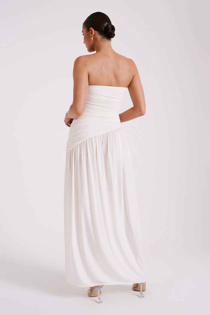 Woman wearing white strapless Bex Slinky Dress with ruched bodice and high slit — Meshki | Endless UAE