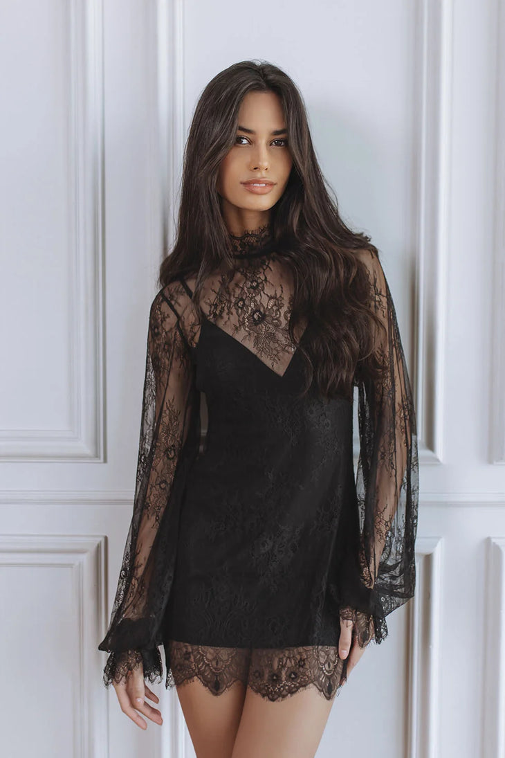 Woman wearing black lace mini dress with sheer long sleeves — Chic Le Frique | Endless UAE