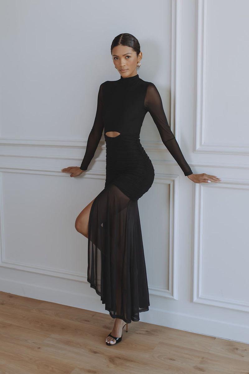 Woman wearing black Juni Maxi Dress with cutout waist and sheer skirt — Chic Le Frique | Endless UAE