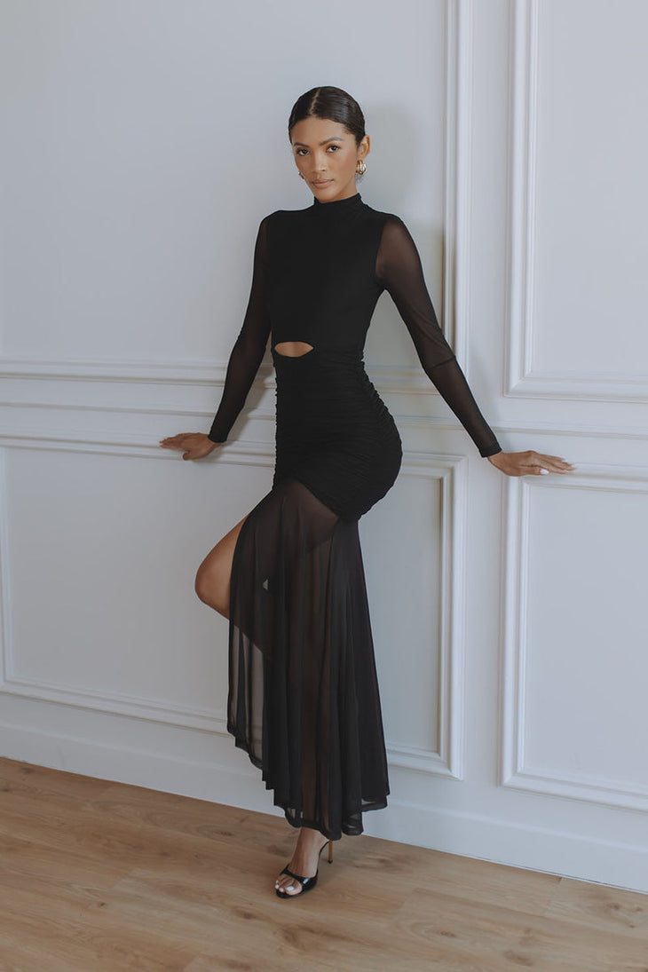 Woman wearing black Juni Maxi Dress with cutout waist and sheer skirt — Chic Le Frique | Endless UAE