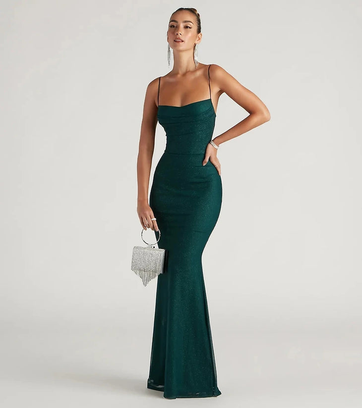 Emerald green mermaid gown with spaghetti straps and silver fringe clutch — Windsor | Endless UAE