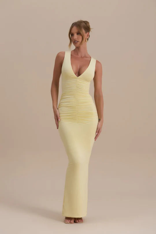 Woman wearing a pale yellow sleeveless maxi dress with ruched detailing — Wanderdoll | Endless UAE