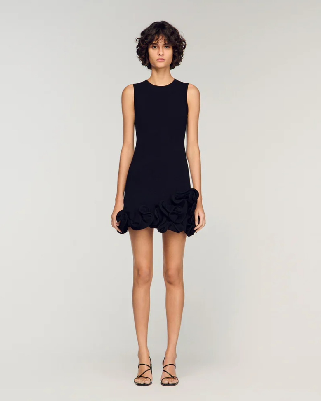 Sleeveless black knit dress with ruffled floral hem detail — Sandro | Endless UAE