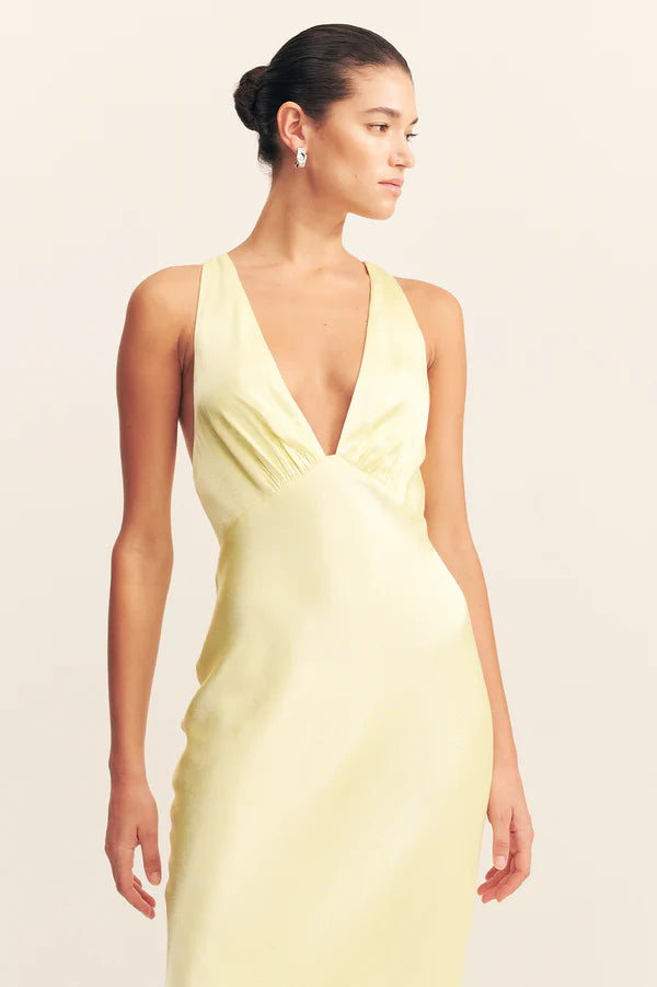 Woman wearing yellow sleeveless plunged neckline maxi dress with cross back detail — Shona Joy | Endless UAE
