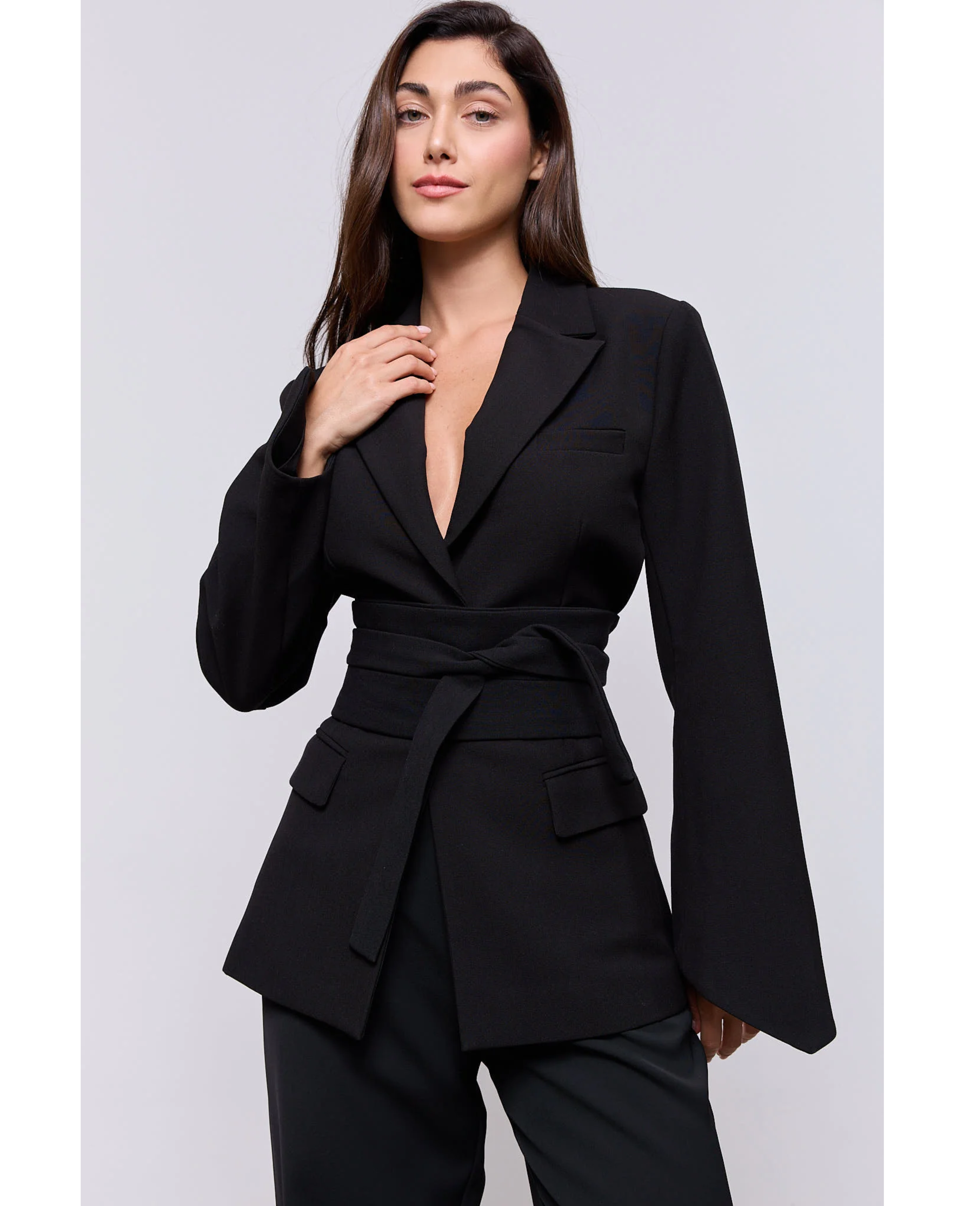 Woman wearing a black belted blazer with long sleeves and matching trousers — Odd Muse | Endless UAE