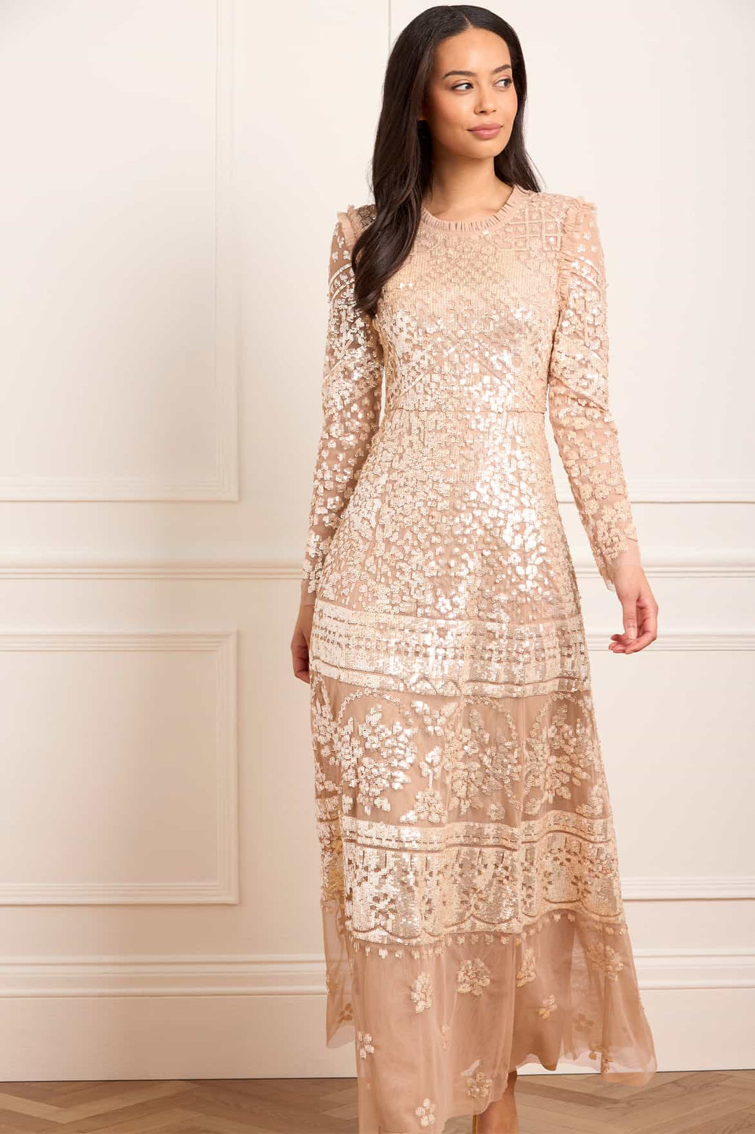 Woman wearing blush sequined Aurora Gown with long sleeves and tiered lace detailing — Needle & Thread | Endless UAE