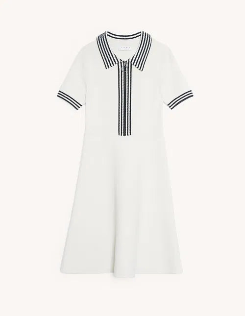 Woman wearing cream polo-style knitted dress with striped trim, sitting on chair — Sandro | Endless UAE