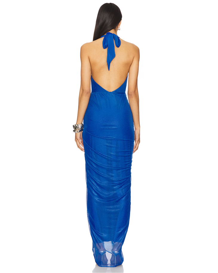 Woman wearing royal blue halter wrap maxi dress with draped side slit and gold accessories — Baobab | Endless UAE