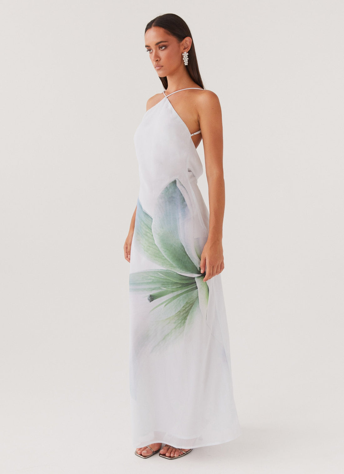 Woman wearing white halter maxi dress with green floral print — Peppermayo | Endless UAE