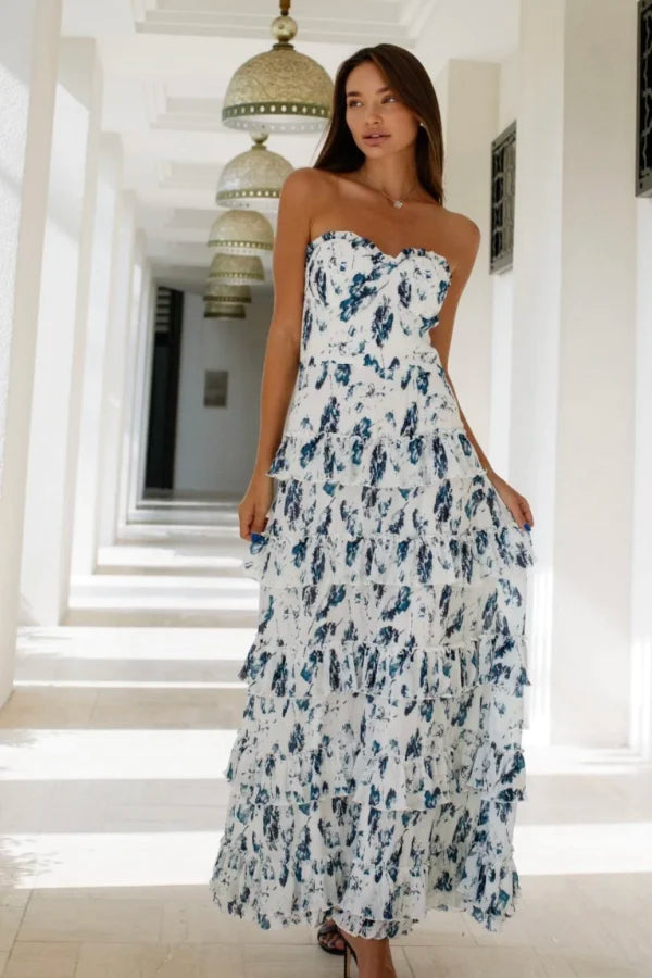 Woman wearing white and navy floral strapless maxi dress in hallway — Anne Louise Boutique | Endless UAE