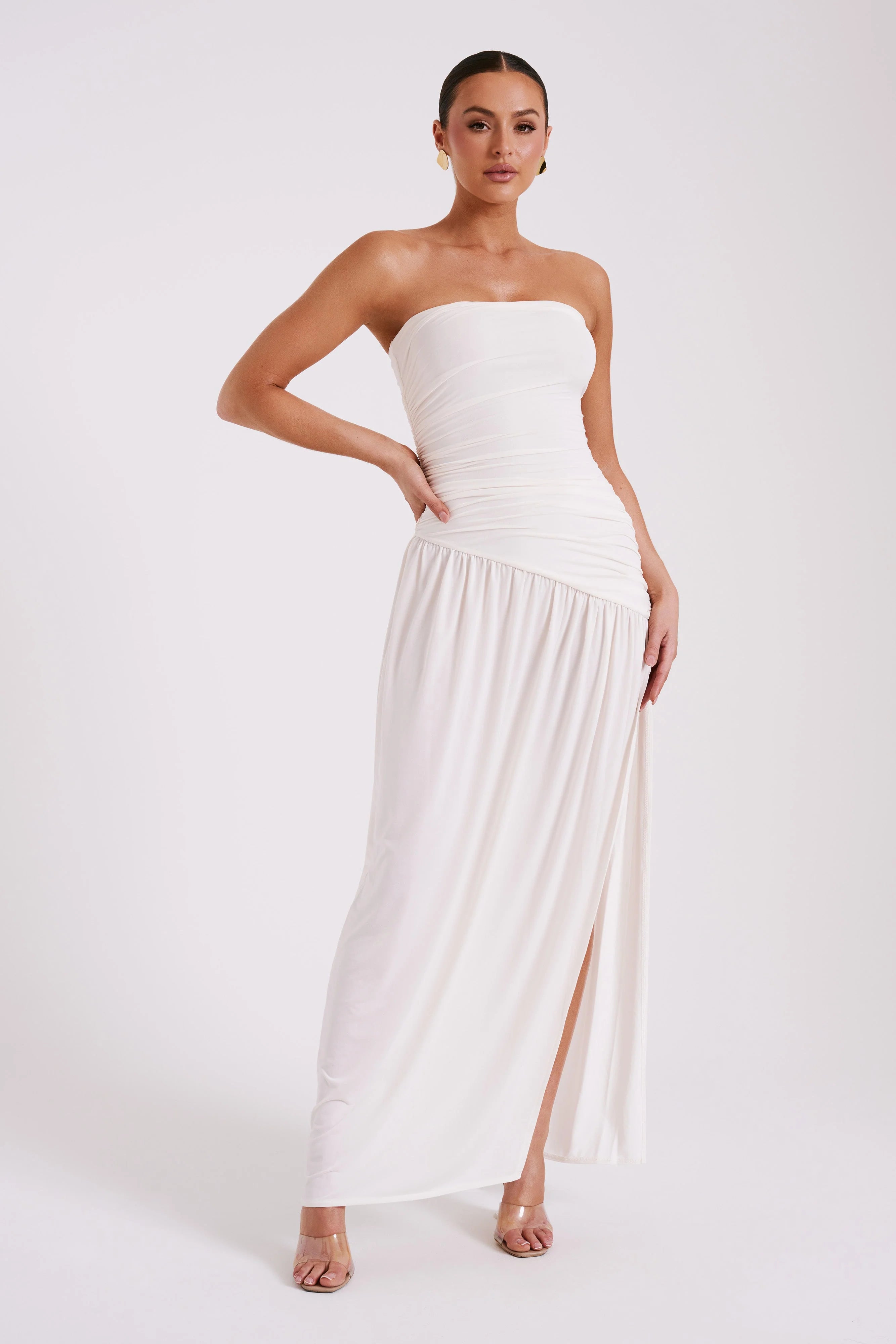 Woman wearing white strapless Bex Slinky Dress with ruched bodice and high slit — Meshki | Endless UAE