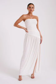 Woman wearing white strapless Bex Slinky Dress with ruched bodice and high slit — Meshki | Endless UAE