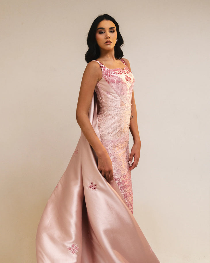 Woman wearing pink embroidered square-neck dress holding thread spools — Reema Dahbour | Endless UAE