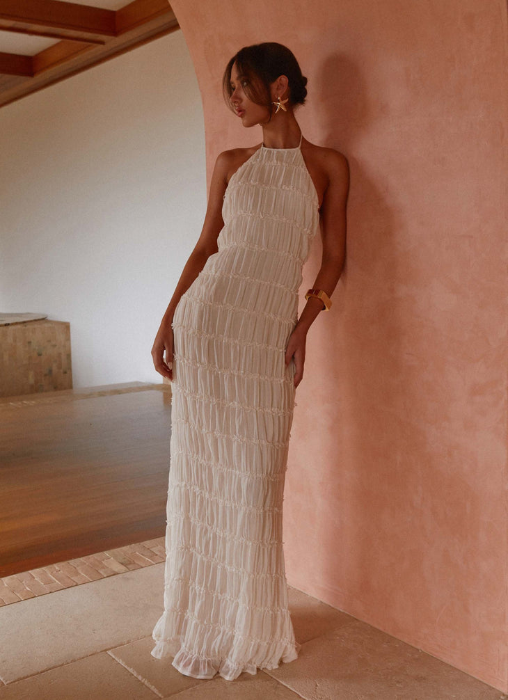 Woman wearing white pleated halter maxi dress in modern interior space — Peppermayo | Endless UAE