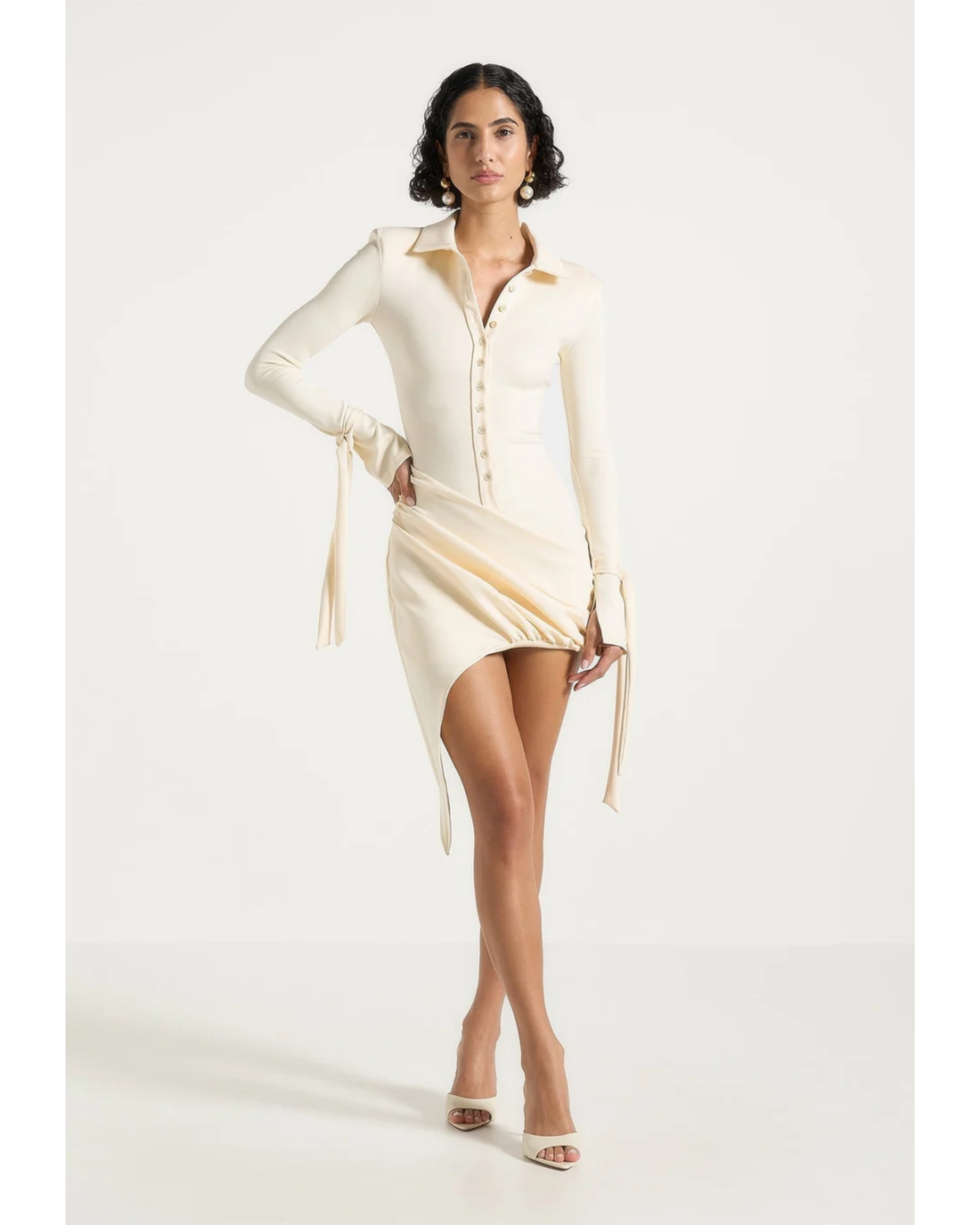 Cream draped asymmetric mini dress with long sleeves and tie detail — Maniere De Voir | Endless UAE