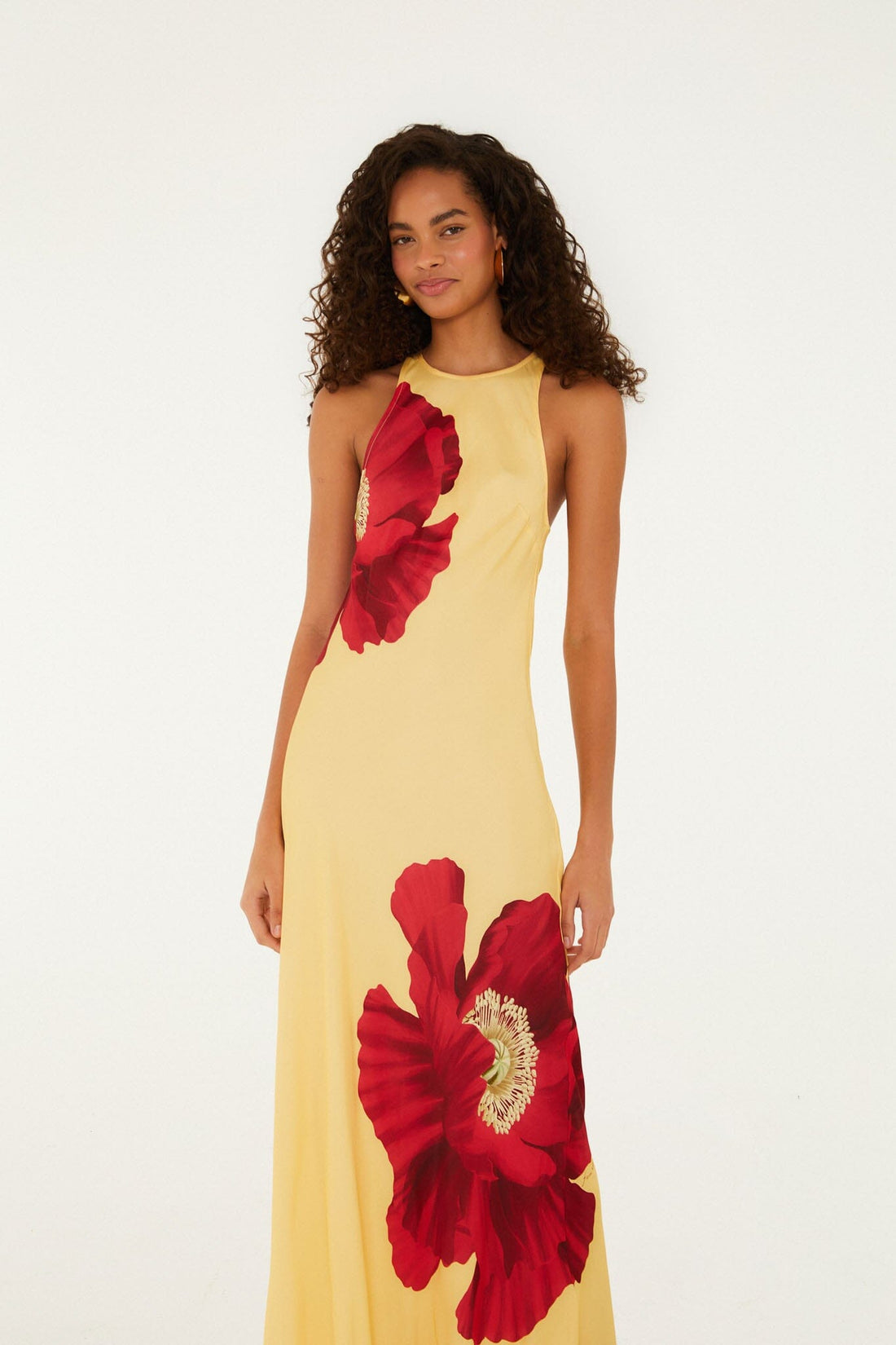 Woman wearing yellow sleeveless maxi dress with red poppy flower print — Farm Rio | Endless UAE