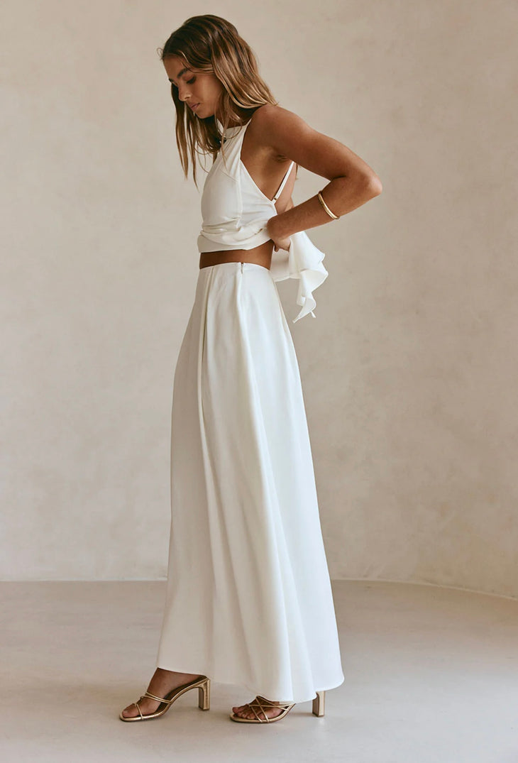 Woman wearing white sleeveless Hailey Co-ord Set with layered skirt and strappy sandals — SABO | Endless UAE