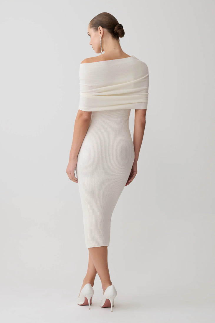 Woman wearing cream cashmere blend knit midi dress with draped off-shoulder overlay and white pointed heels — Meshki | Endless UAE