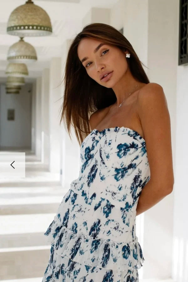 Woman wearing white and navy floral strapless maxi dress in hallway — Anne Louise Boutique | Endless UAE